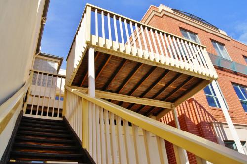 a staircase leading up to a building with a deck at Fire Station Inn in Adelaide