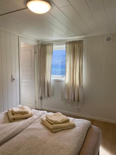 een slaapkamer met een bed met twee handdoeken erop bij Aurland Feriehus in Aurland