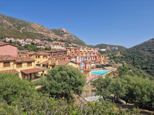 a village on the side of a mountain at La Perla e le Conchiglie Tanca Piras vista mare in Nebida