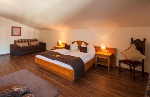 a hotel room with a bed and a couch at Appartementhaus Leitner in Ehrwald