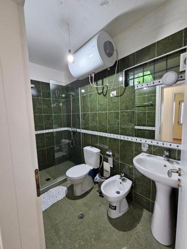 a bathroom with two toilets and a sink at Villa Dario in Vlorë