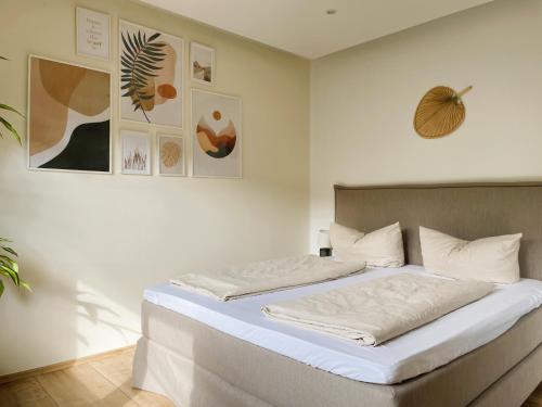 a bedroom with a large bed with white sheets at Finca Berlin nähe Olympiastadion in Berlin