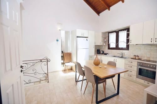 a kitchen with a table and chairs in a room at Kores Villas in Nydri