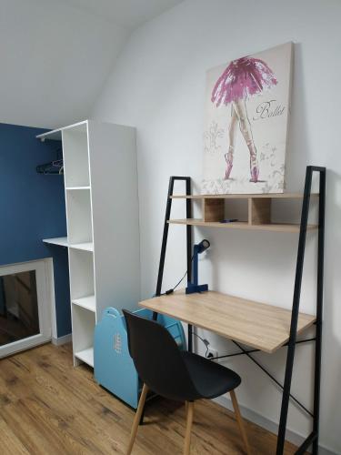 a desk and a chair in a room at Gîte : Le Castel des Anges in Marigny-Marmande