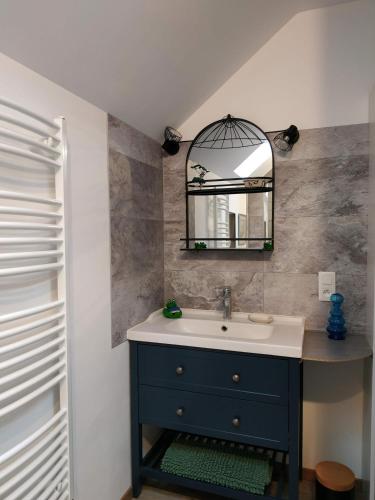a bathroom with a blue sink and a mirror at Gîte : Le Castel des Anges in Marigny-Marmande