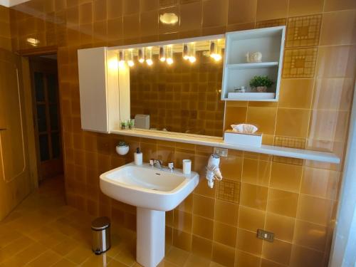 a bathroom with a sink and a mirror at Casa alla Fontana in Serravalle allʼAdige