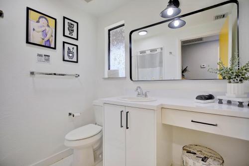 a bathroom with a sink and a toilet and a mirror at Chic Retreat in Sebring