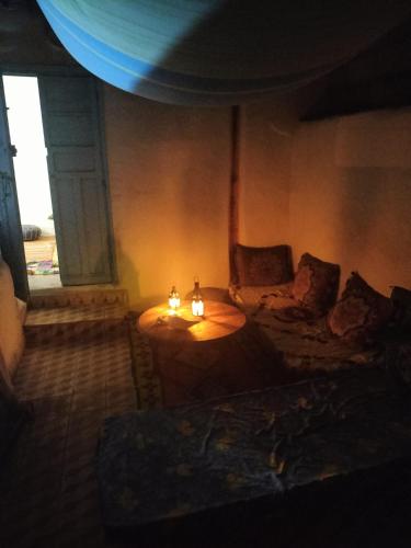 a living room with a table and a couch at casa tradicional marroqui in Sidi Ifni