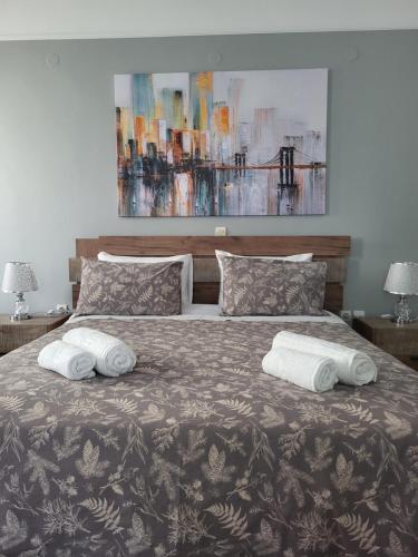 a bedroom with a bed with two towels on it at DIMITRA STUDIOS in Lefkada Town