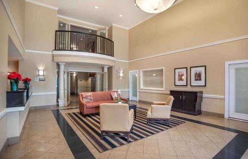 a living room with a couch and chairs and a tv at Extended Stay America Suites - Columbia - Columbia Corporate Park in Columbia