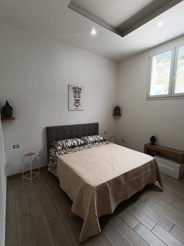 a bedroom with a large bed in a white room at Casa di Hermes in Pizzo