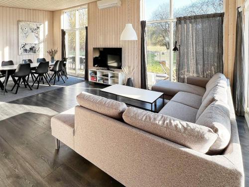 a living room with a couch and a table at 8 person holiday home in Glesborg in Fjellerup Strand
