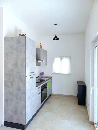 a kitchen with a large stainless steel refrigerator at Casa Daniel in Selva di Fasano