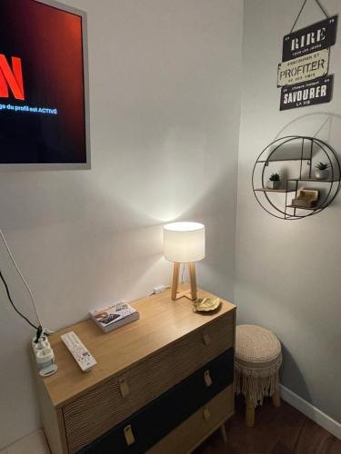 una mesa con una lámpara encima de un tocador en LE CARPE DIEM - Centre-ville - WIFI - Netflix, en Niort