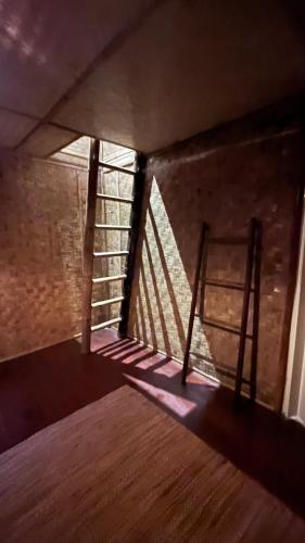 a dark room with a window and a wooden floor at Chakerpor bamboo house 3 in Ban Mae Sapok Noi