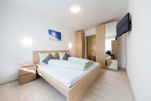 a bedroom with a bed and a flat screen tv at Haus Luigi in Sölden