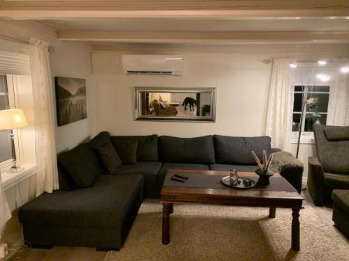 a living room with a couch and a coffee table at Rikstaddal in Kalvhagen