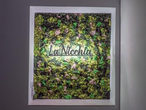a framed picture of a wall covered in flowers at LA NICCHIA in Cesena