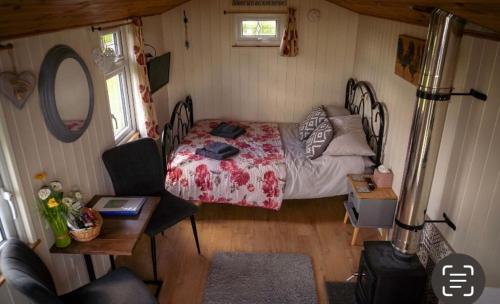 a bedroom with a bed and a desk and a table sidx sidx sidx at Maple Hut Four Acre Farm in Aylsham