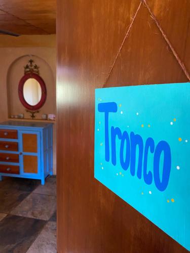 a sign on a wall in a room with a dresser at Hotel Restaurante Mi Jardin Troncones in Troncones
