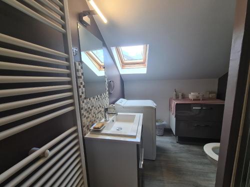 a small bathroom with a sink and a window at Charmante maison avec jardin, au cœur du Berry, proche rivière et randonnées - FR-1-591-57 in Chasseneuil