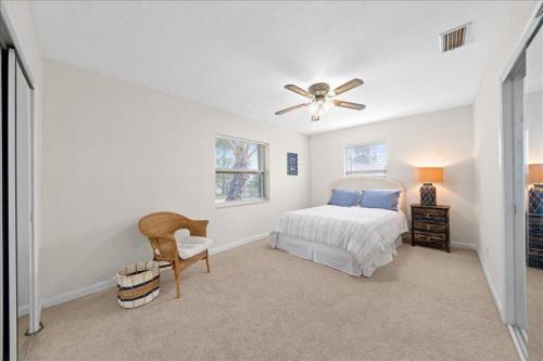 a bedroom with a bed and a ceiling fan at Coastal Chic Home, Walk to Beach in Cocoa Beach