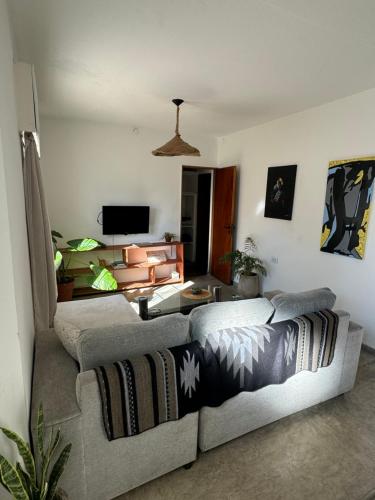 un salon avec un canapé et une télévision dans l'établissement Casa Raíz, à Santa Rosa de Calamuchita