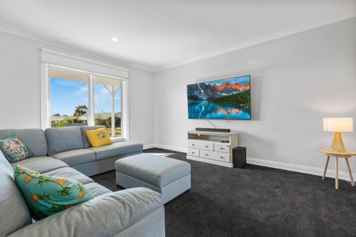 a living room with a couch and a table at Jewel on Crown in Paynesville