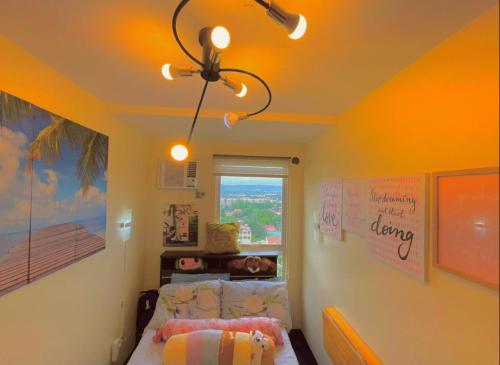 a bedroom with a bed and a ceiling fan at Pandora’s Nest in Manila