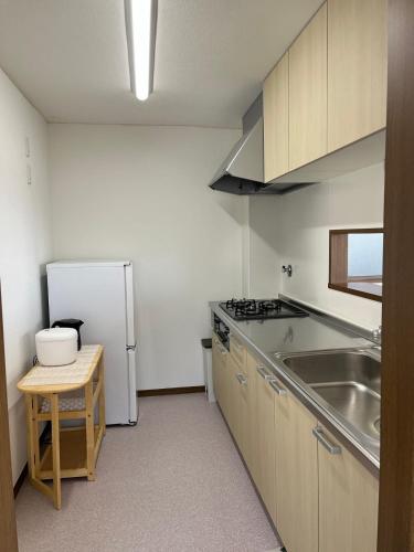 a kitchen with a sink and a refrigerator at N's Home - 南名古屋駅一軒家 - 8 in Nagoya