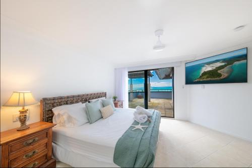 エアリービーチにあるWaters Edge Penthouseの海の見えるベッドのある寝室
