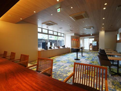 a waiting room with a long table and chairs at Hotel New Gaea Yakuin in Fukuoka