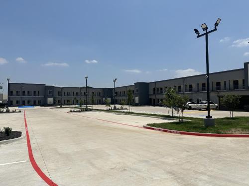 an empty parking lot in front of a building at M&M Inn and Suites in Fort Worth