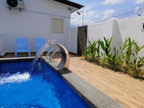 a pool with a water slide in a house at casa261 HOMESTAY PD in Port Dickson