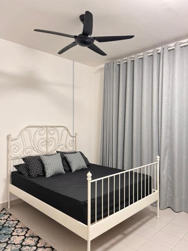 a bedroom with a bed with a ceiling fan at Homestay Bandar Mahkota Banting in Banting