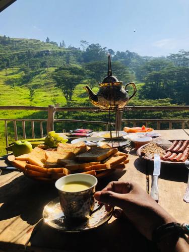 a table with a plate of bread and a cup of coffee at Dunali Mountains - Galaha in Galaha Town