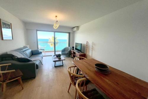 a living room with a couch and a table at Juan les Pins - Sea View - 4 people - Parking in Juan-les-Pins