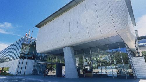 a large building with a lot of glass windows at REF Matsuyama City Station by VESSEL HOTELS in Matsuyama