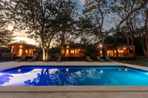 a swimming pool in front of a house at Dos Mares Venao Village in Playa Venao
