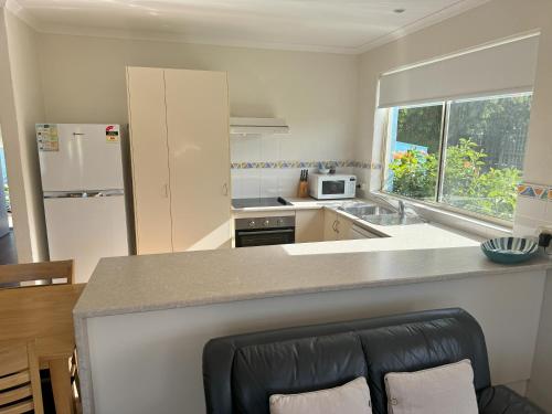 a kitchen with a counter top and a refrigerator at BlueWater Apartments in Merimbula