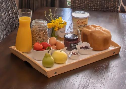a tray of food with fruits and vegetables on a table at Serenity House Pemberton Cottage & Wellness Spa in Pemberton