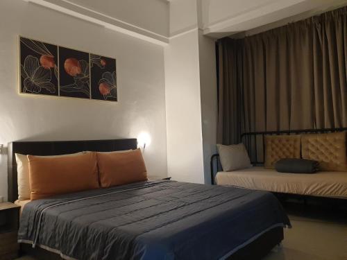 a hotel room with a bed and a couch at 1Bedroom Urban Oasis Retreat in Melaka