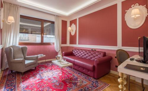 a living room with a couch and a chair at Grande Albergo Roma in Piacenza