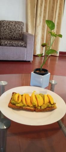 a plate of food with bananas on a table at Dishari Tangalle in Tangalle