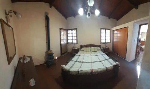 a room with two large beds in a room at Yanasuspa Huasin & Sol del Pilar in Tafí del Valle