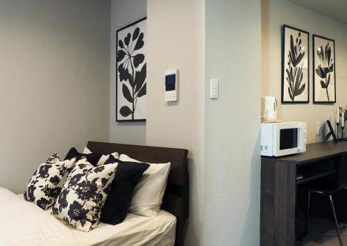 Ένα ή περισσότερα κρεβάτια σε δωμάτιο στο LANG Hotel Kameido#Near Akihabara#チェックアウトのみ清掃あり