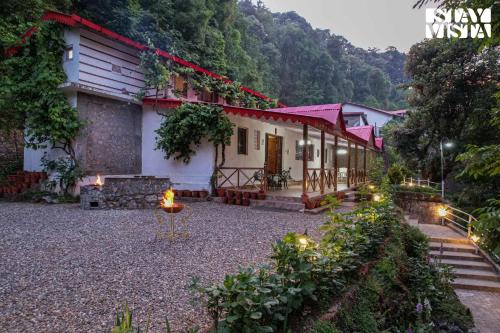 a house in the mountains with lights in the yard at StayVista at Edwinstowe House with Heater, Bonfire & BBQ Grill in Nainital