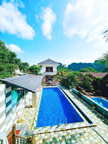 an image of a swimming pool in front of a house at The Ridge Haven in Phong Nha