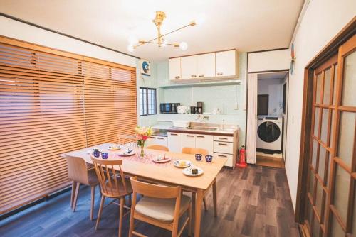 a kitchen with a table and chairs in a room at New! Kamata close Haneda AP - Traditional & Hot Spring in Tokyo