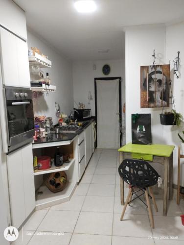 a kitchen with a table and a green table at Josefina casa in Punta Alta